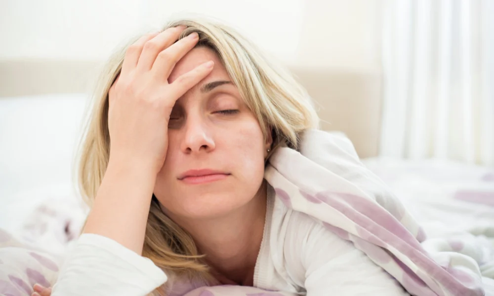 a sleepy woman who doesn't want to get out of bed