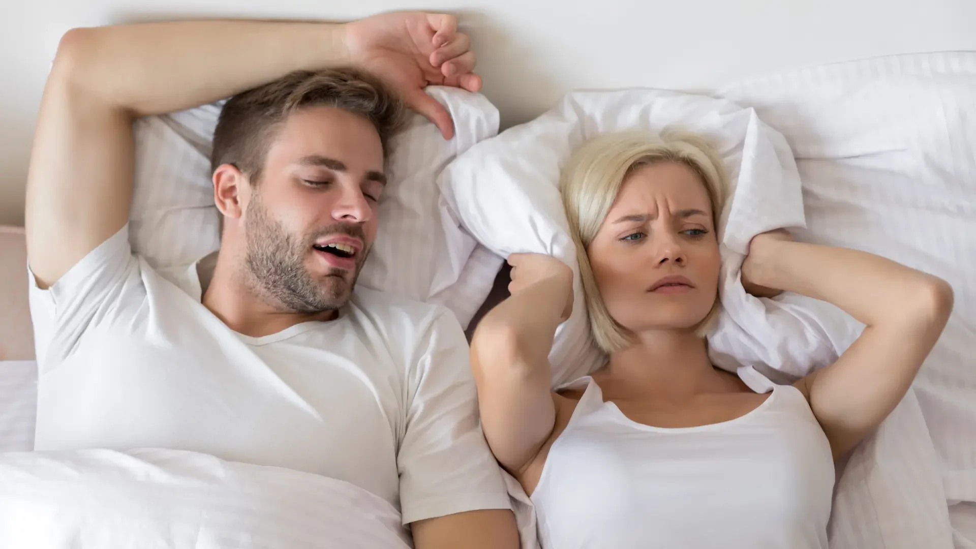 A man's snoring prevents a woman from sleeping