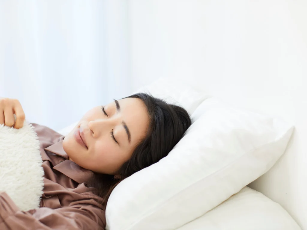 Man lying on a pillow with a blocked nose, struggling to sleep